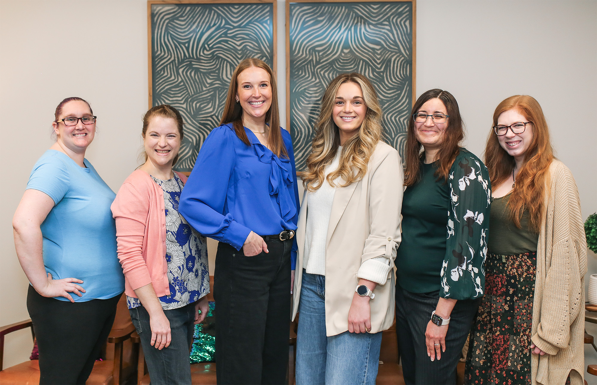 Six female therapists on the Zola Counseling team standing in a play therapy office.